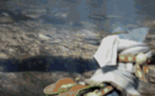 a blurred image of a person sitting on a rock .