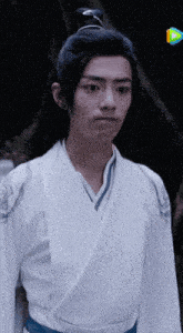 a man in a white kimono with a blue ribbon around his waist
