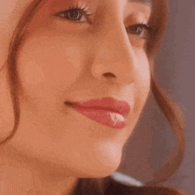 a close up of a woman 's face with red lipstick on