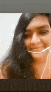 a woman wearing a headset is smiling and looking at the camera