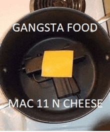 a gun with a piece of cheese in it is in a pan .