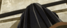 a close up of a person 's head with a black skirt covering it