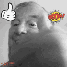 a black and white photo of a man 's face with a mickey mouse hand giving a thumbs up next to a boom sign