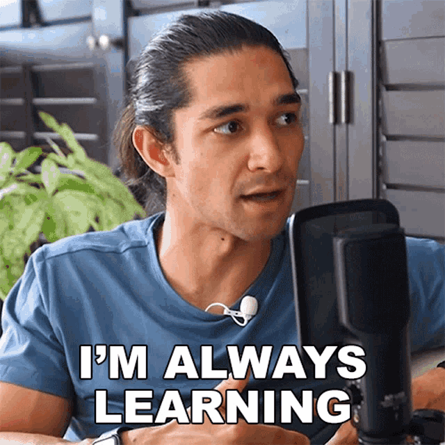 a man says i 'm always learning while talking into a microphone