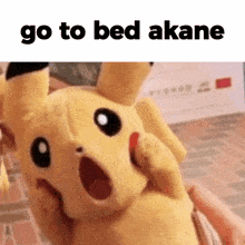 a person is holding a pikachu stuffed animal with their mouth open and the words `` go to bed akane '' above it .