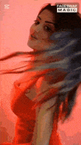 a woman in a red dress with her hair blowing in the wind