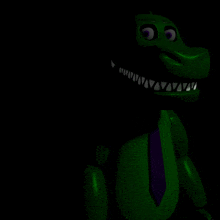 a green dinosaur with purple eyes and a purple tie is sitting in the dark