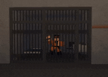 a person is behind bars in a jail cell .