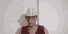 a man wearing glasses and a hat with the word wow on it