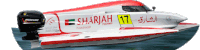 a red and white boat with sharjah 17 written on the side