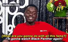 a man in a red shirt is smiling and saying `` what are you gonna do with all this fame ? ``