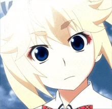 a girl with blonde hair and blue eyes looks angry
