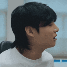 a close up of a man 's face with a mullet haircut