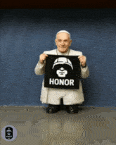 a statue of a pope holding a black banner that says honor