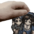 a hand is holding a picture of a man and a woman .