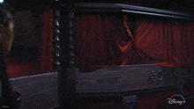 a close up of a woman 's face with a disney+ logo in the corner