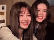 two girls are smiling for a picture and the name nfjlaerie is on the bottom left