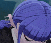 a close up of a person 's ear with a purple hair clip .