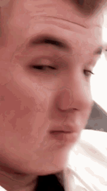 a close up of a man 's face with his eyes closed and his mouth open .