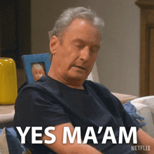 a man is sitting on a couch with his eyes closed and the words yes ma 'am on the bottom