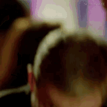 a close up of a person wearing headphones in a crowd .