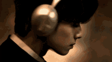 a close up of a person wearing headphones on their ears