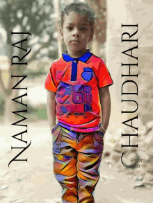 a young boy wearing an orange shirt with the number 26 on it stands with his hands in his pockets