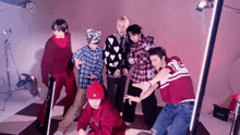 a group of young men are posing for a picture together in a room .