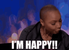 a woman says i 'm happy in front of a blue background