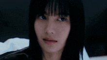 a close up of a woman looking at herself in a mirror and smiling .