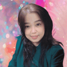 a woman in a green jacket is smiling in front of a colorful background