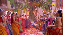 a group of women are dancing in a room with a star in the corner .