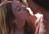 a close up of two women kissing with the words lingomouse visible