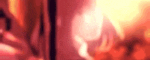 a blurred image of a person standing in front of a fire with a red background .
