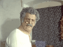 a man with glasses and a mustache looks angry