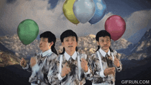 three men are holding balloons in front of mountains and the website gifrun.com is displayed