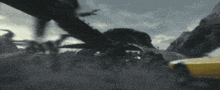 a yellow car is being chased by a large black spider