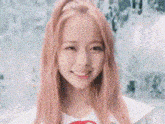 a close up of a woman with pink hair and a white shirt smiling .