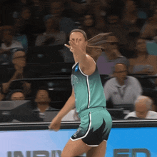 a female basketball player wearing a jersey that says ' nba ' on it