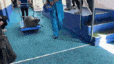 a seal is being pushed on a cart with a sign behind it that says ' a ' on it