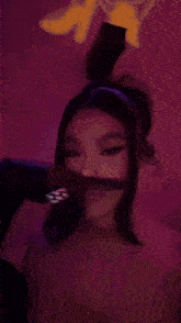 a woman is sticking her tongue out at the camera .