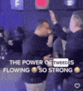 a group of men are standing next to each other in a room and giving each other a high five .
