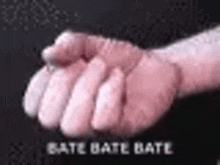 a close up of a person 's hand with the words bate bate bate written on the bottom .
