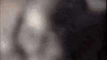 a close up of a person 's face with a blurred background