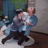 two men are fighting in a room with chinese writing on the wall behind them .