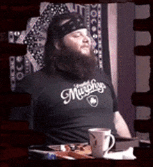 a man with a beard wearing a shirt that says murphys