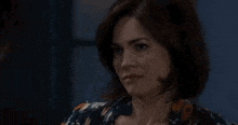 a close up of a woman 's face in a room .