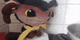 a stuffed animal with a yellow ribbon around it