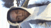 a man wearing a white hoodie with a hood