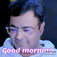 a man wearing glasses says good morning on a photo